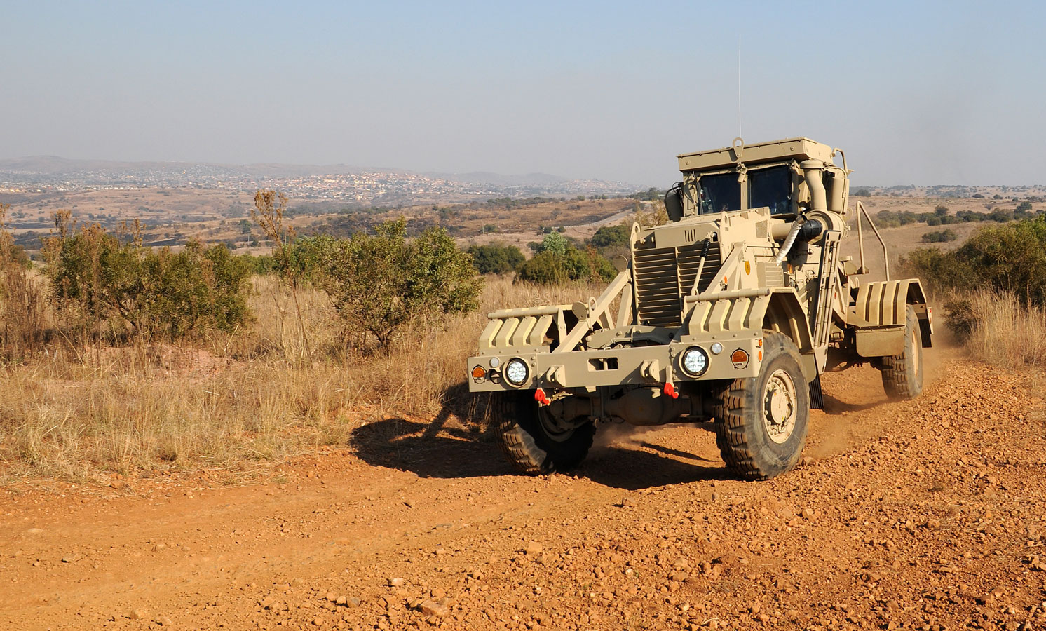 Husky vehicle driving in a desert landscape