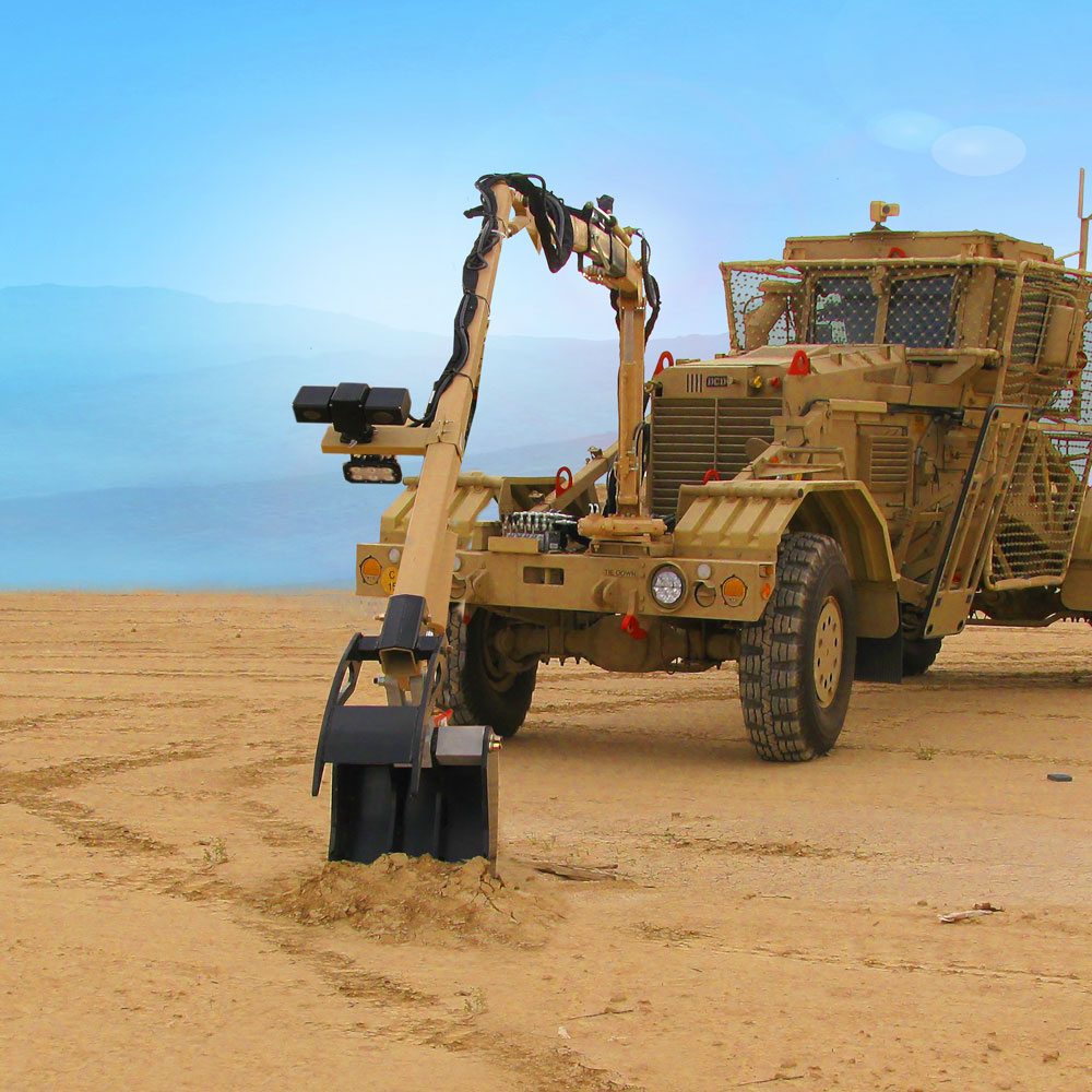 Interrogation arm mounted on a Husky digging in sand