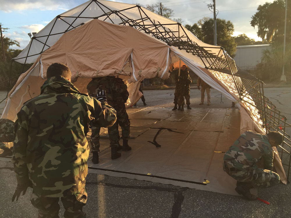 Soldiers erecting a First Response Shelter